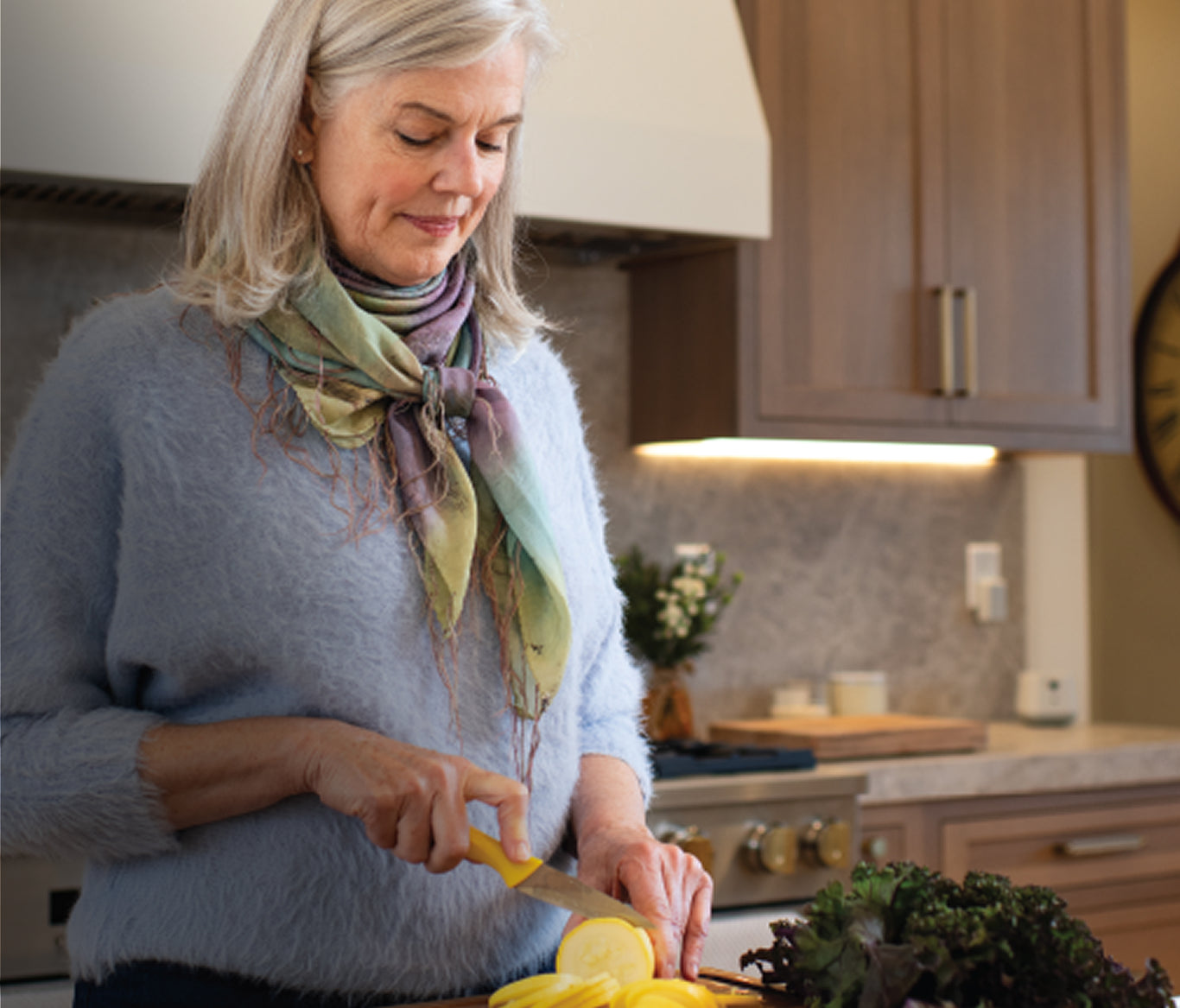Woman Cutting Food During Mealtimes while Using Nomo Elderly Monitoring System