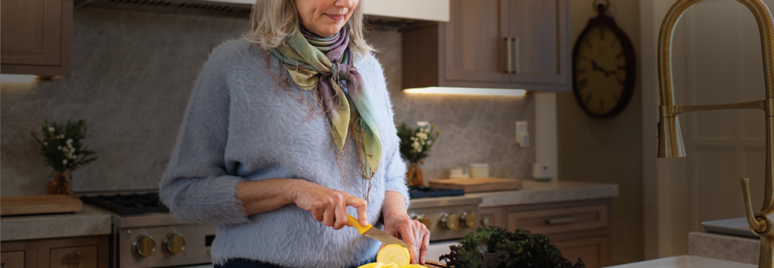 Woman Cutting Food During Mealtimes while Using Nomo Elderly Monitoring System