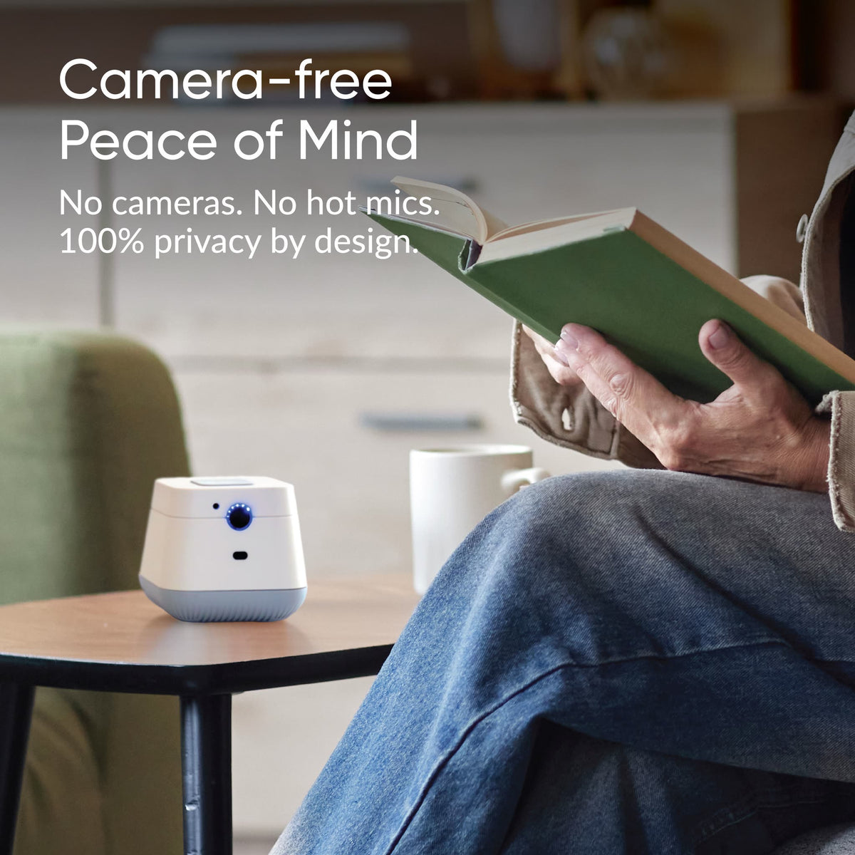 Person reading beside a Hub: camera-free peace of mind, no cameras or hot mics, privacy by design.