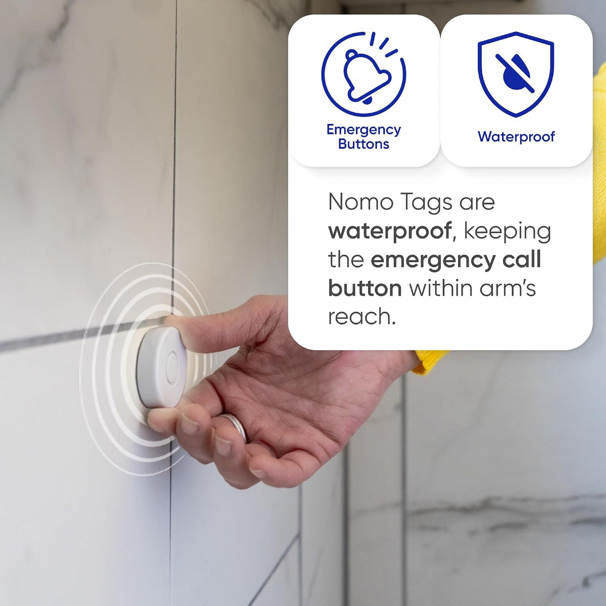 Hand presses a wall-mounted Tag in a bathroom; waterproof emergency call button stays within reach.
