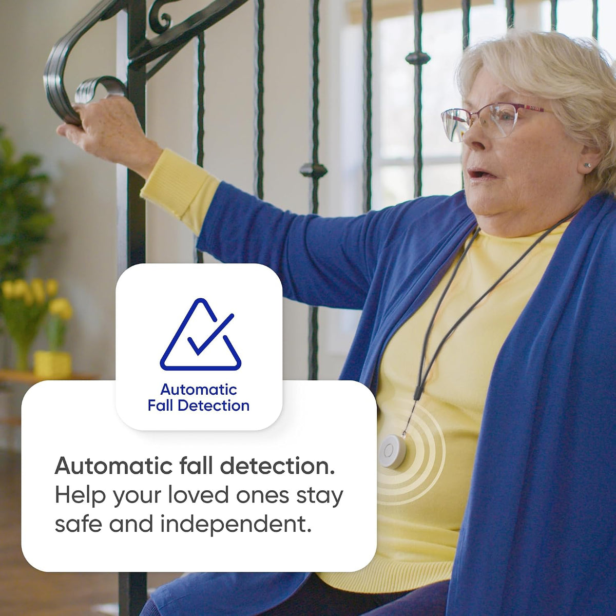 Woman wearing a Tag pendant on stairs; automatic fall detection helps loved ones stay safe and independent.