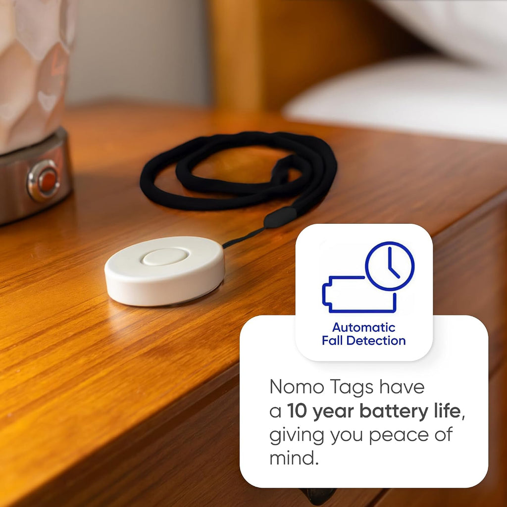Tag pendant on a bedside table: 10-year battery life and automatic fall detection.
