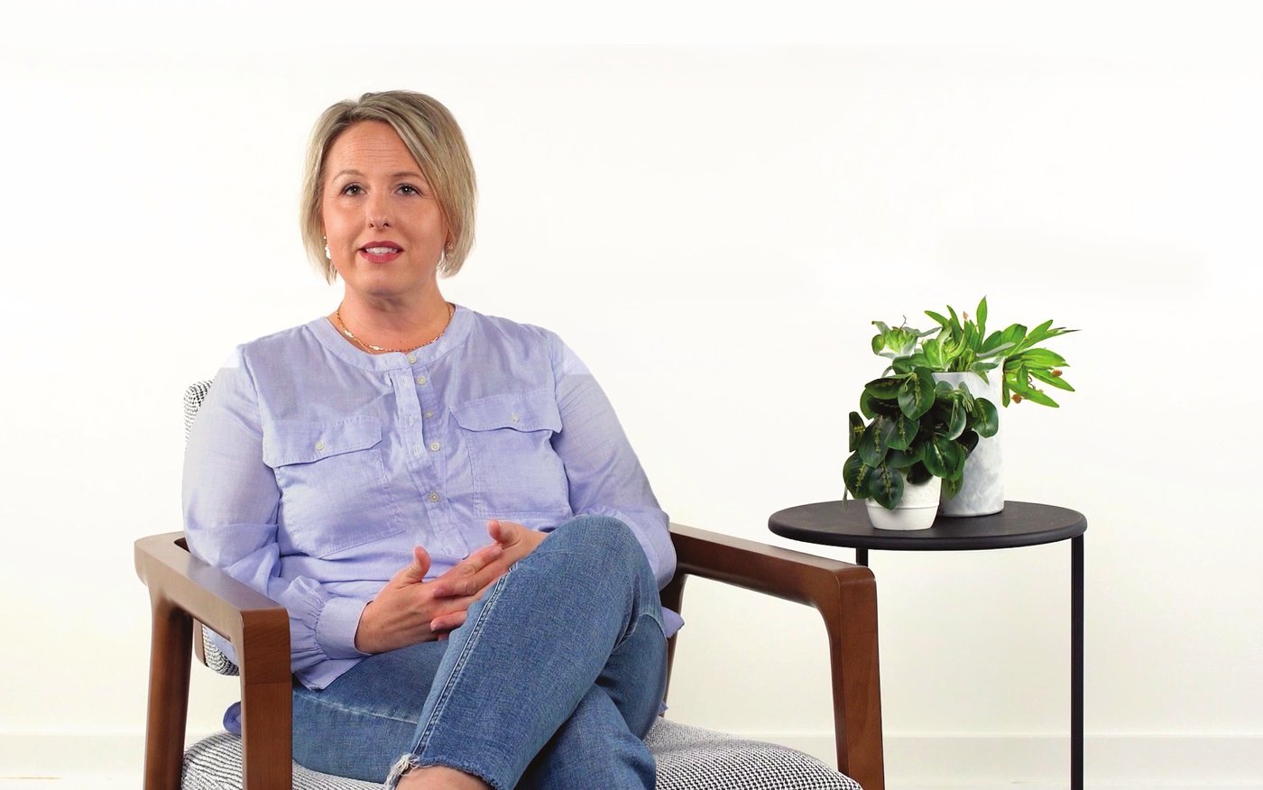 Megan, a Nomo Smart Care user, seated in an interview chair