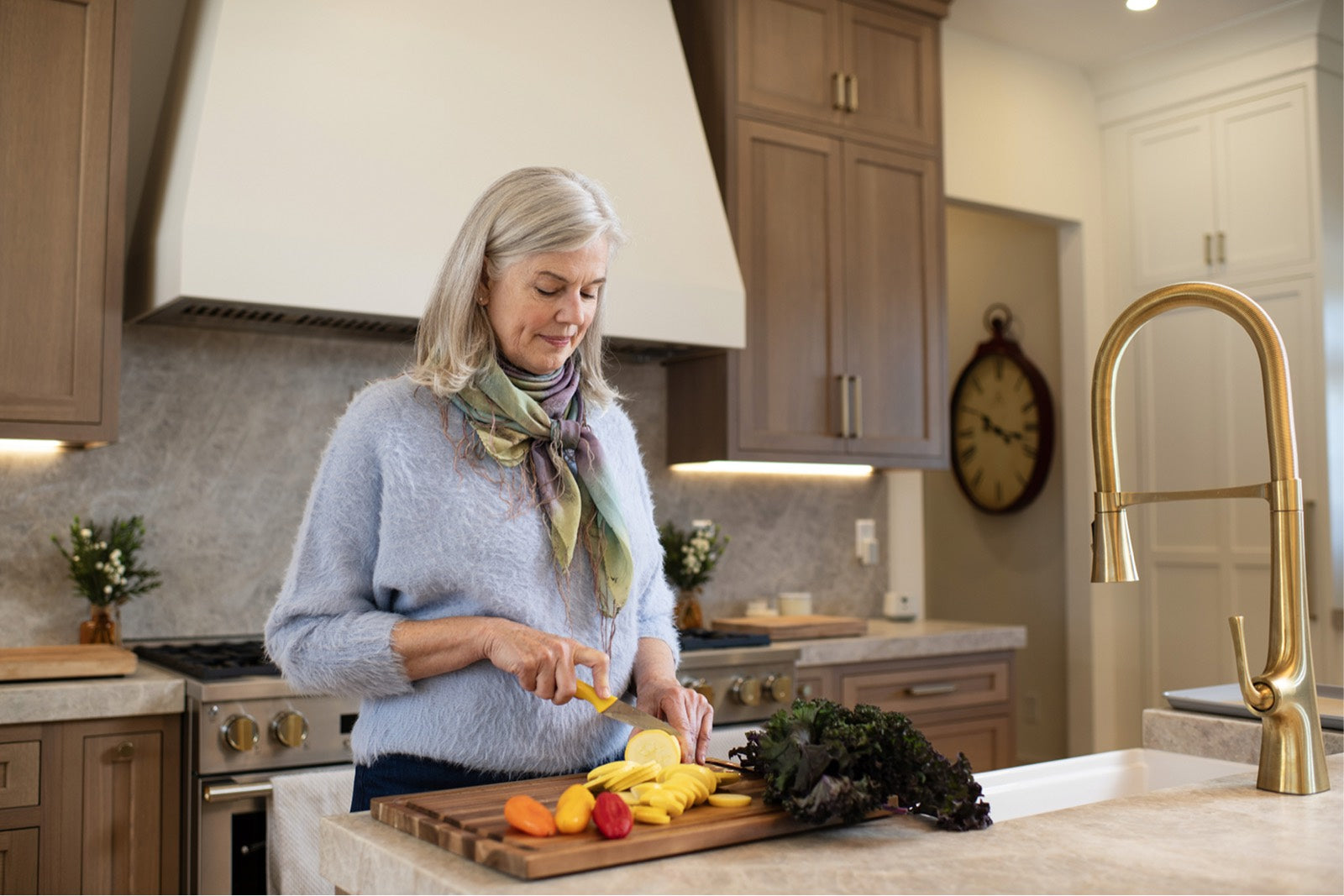 A woman prepares vegetables at her kitchen counter
