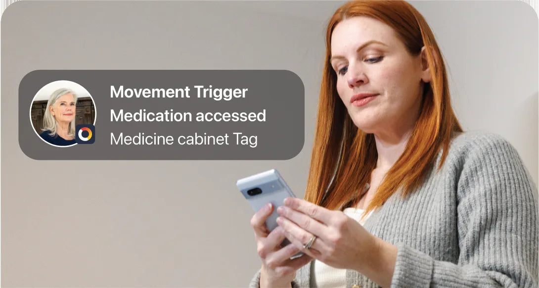A woman reads a Movement Trigger on her phone: Medication accessed, Medicine cabinet Tag