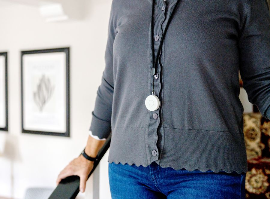 A woman wearing a Nomo Tag as a pendant on a lanyard