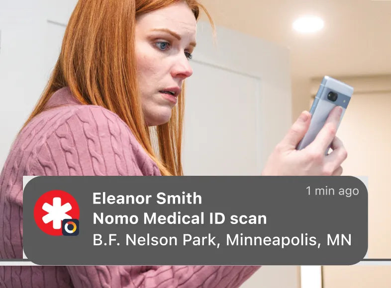 A worried woman reads a phone notification: Eleanor Smith, Nomo Medical ID scan, B.F. Nelson Park, Minneapolis, MN, 1 min ago