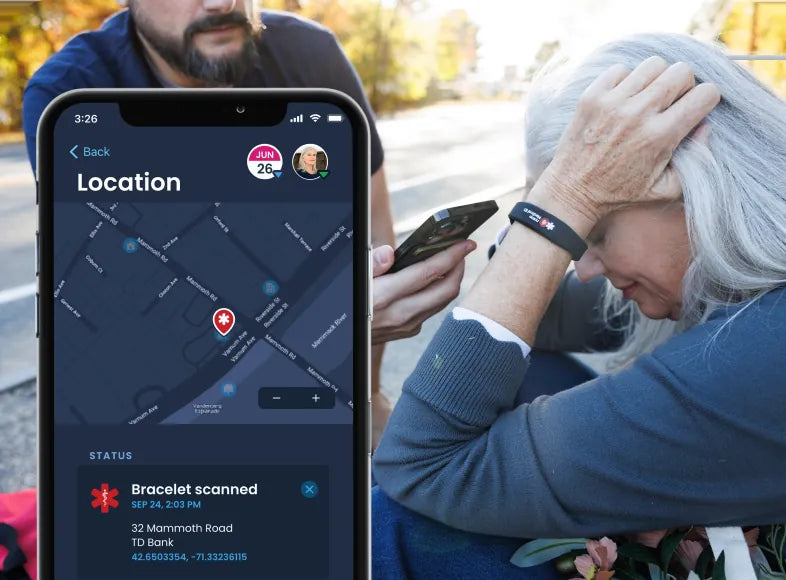 A phone shows a map with the location where the bracelet was scanned, beside an older woman being helped outdoors